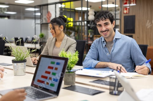 Preview: Business professionals working in modern office meeting