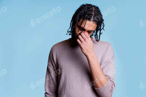 Preview: Tired arab man holding nose, suffering from sinus pain