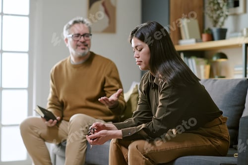 Preview: Middle Aged Man Comforting Upset Young Adult Woman Indoors