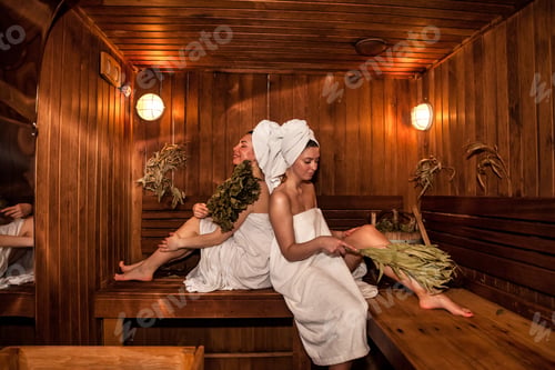 Preview: Two women resting leisure in wooden sauna with hot steam. Russian bathhouse
