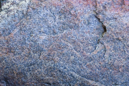 Preview: Texture Of Granite Close Up. Granite Rock With Reddish Color. Background From Solid Stone. Pattern