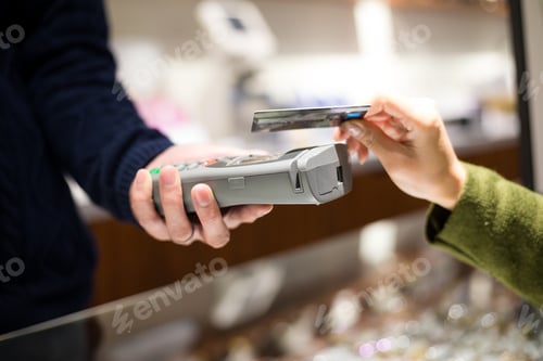 Preview: Woman pay with mobile phone by NFC
