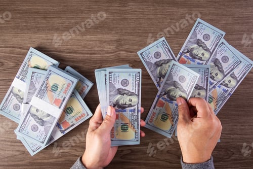 Preview: woman counting American money or 100 USD dollars note at table,