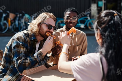 Preview: Young People Eating Pizza Outdoors