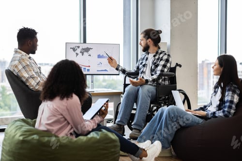 Preview: Diverse team discussing business report and ideas in modern office setting