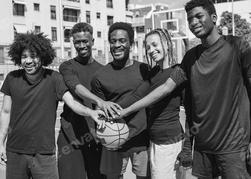 Preview: Happy african people stacking hands on baket ball after match - Young friends and sport concept