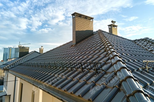 Preview: Closeup snow guard for safety in winter on house roof top
