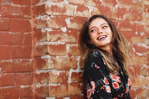 Preview: Portrait of beautiful young woman smiling outdoor