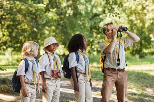Preview: Adult scout leader looking in binoculars