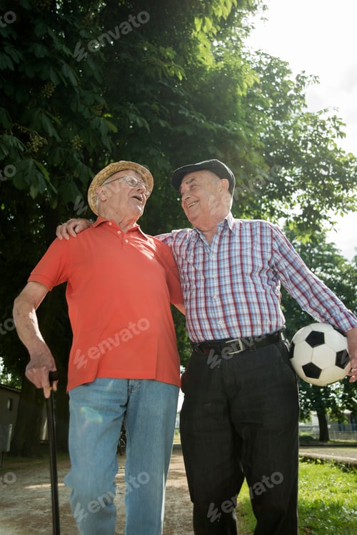 Preview: Two old friends walking in the park with football