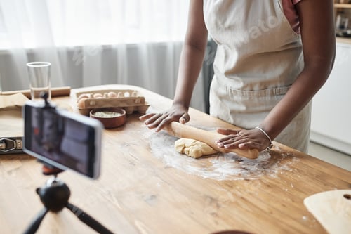 Preview: Black woman baking homemade pastry recording video or livestream