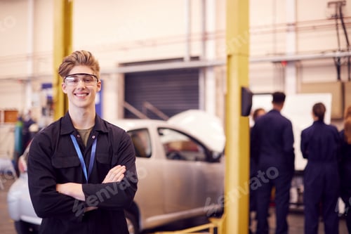 Preview: Portrait Of Male Student Wearing Safety Glasses Studying For Auto Mechanic Apprenticeship At College