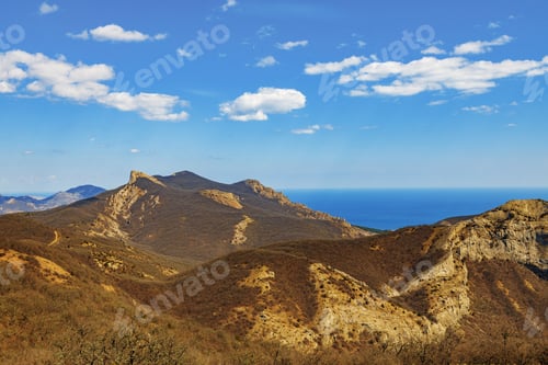 Preview: Mountains landscape against blue sky with clouds on sunny day