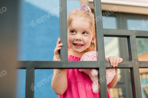 Preview: Happy cute child girl having fun outdoor in summer time. Children and generation alpha concept