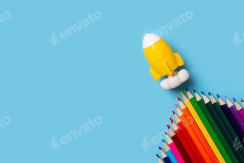 Preview: Back to school theme with colorful pencils and rocket on blue background