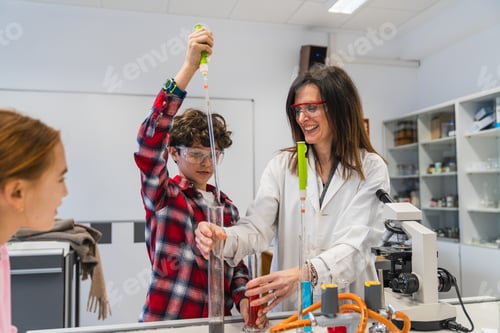 Preview: Students and teacher making experiments in chemistry lab