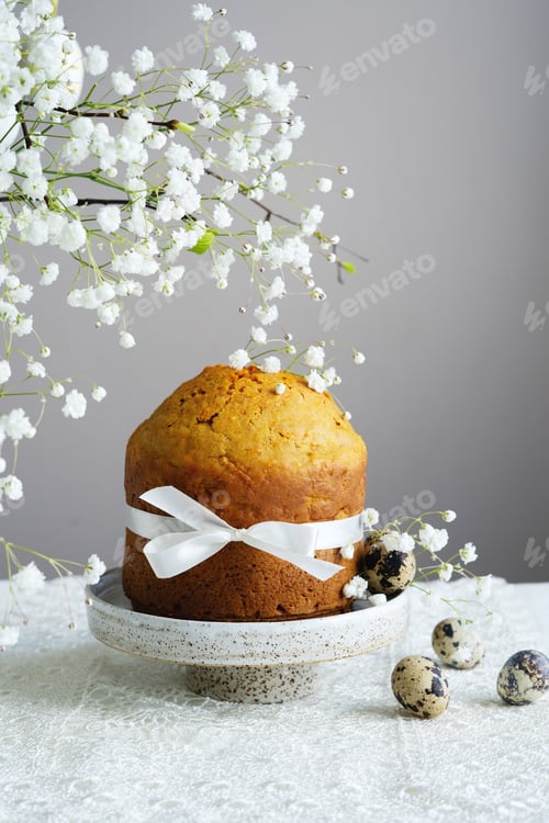 Preview: Handmade easter cake with white flowers and decor on table
