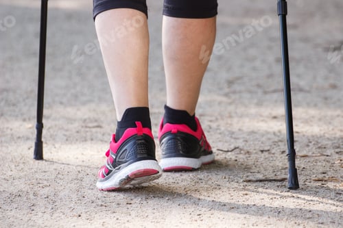 Preview: Legs of elderly senior woman practicing nordic walking, sporty lifestyles in old age concept
