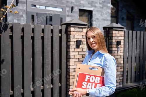 Preview: Realtor with a sign for sale looking at the camera