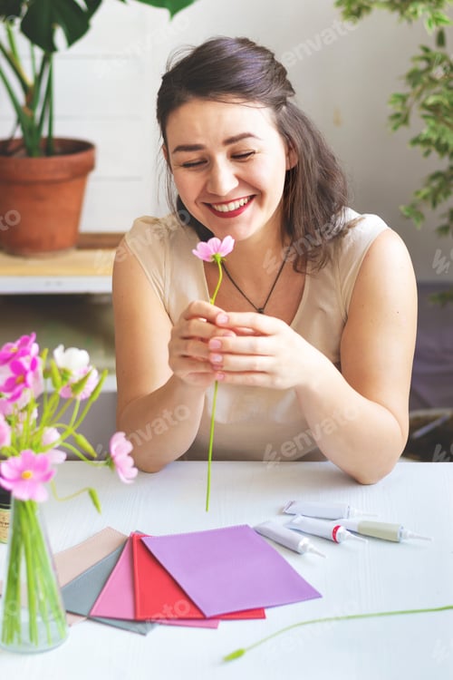 Preview: Woman artisan works in workshop and gets inspired before painting leather goods