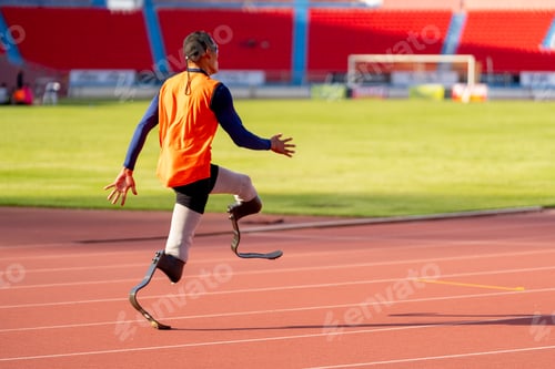 Preview: Asian para-athletes with prosthetic blades sprint on a running track at stadium.