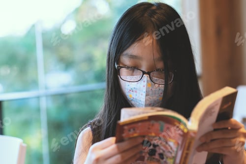 Preview: A little girl who wearing face mask and eyeglasses is reading a comic book