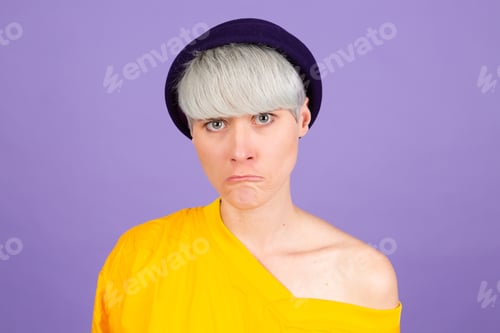Preview: Stylish european woman on purple background sad upset unhappy emotions