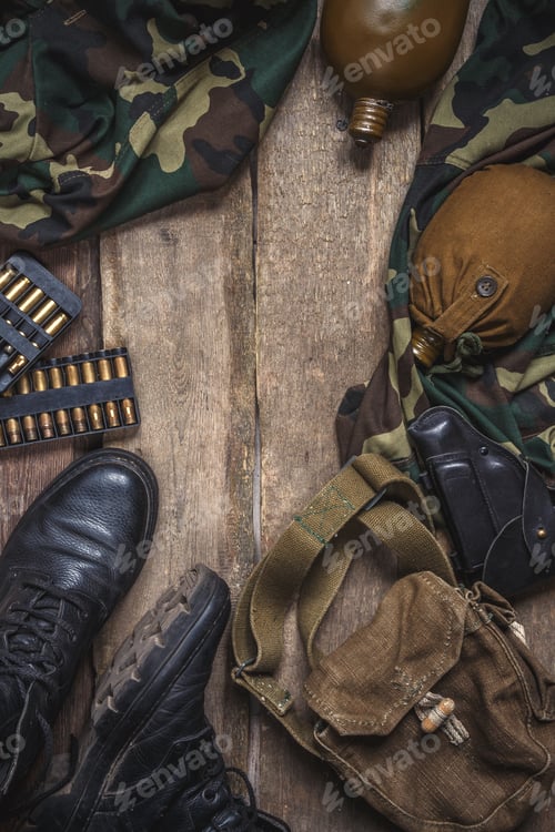 Preview: Army military uniform, weapon, holster, pistol, flask, boots on wooden background. Flat lay top view
