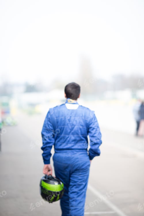 Preview: Man wearing blue and carrying a helmet