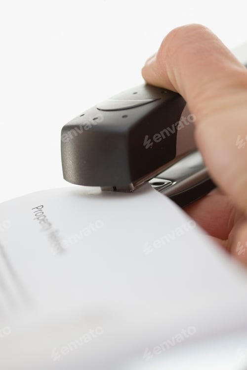 Preview: Close up of woman using stapler