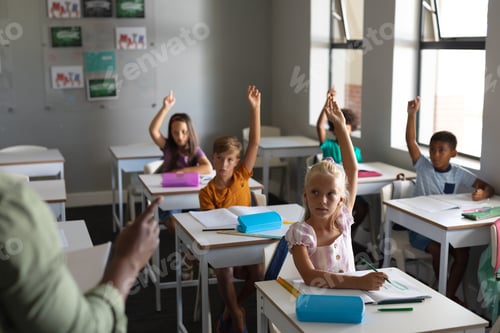 Preview: Children Raise Hands While Sitting at Desks