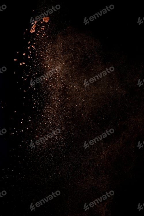 Preview: Cocoa powder explosion in motion. Chocolate dust on a black background. Action food photography.