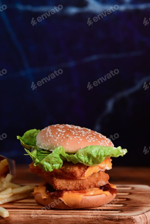 Preview: Tasty homemade fish burger on wooden tray.
