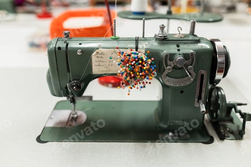 Preview: Sewing machine and pin cushion in textile workshop