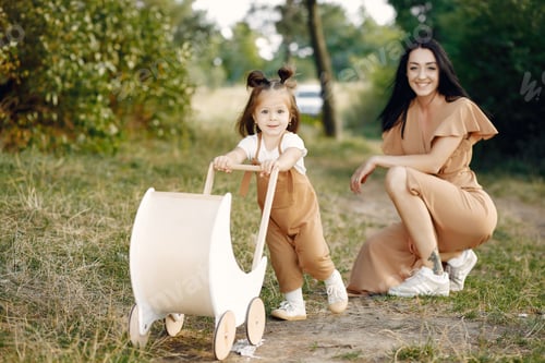 Preview: Mother with little daughter playing in a summer field
