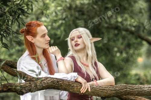 Preview: An elf man and an elf woman are standing near a tree. A pair of stunning detailed elven fantasies