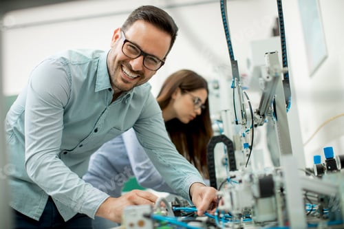 Preview: Young couple of students at robotics lab