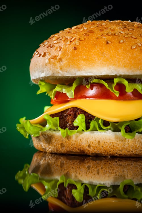 Preview: Tasty and appetizing hamburger on a darkly green