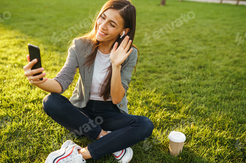 Preview: The girl holds the phone and coffee in hand. Sunset. Summertime.