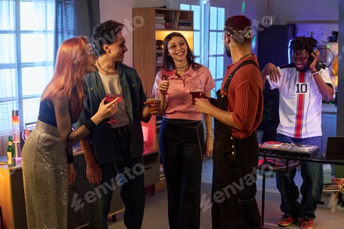 Preview: Group of Multiethnic young People Socializing and Drinking at House Party