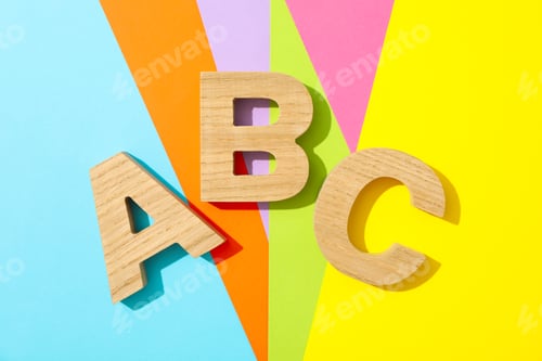 Preview: Letters ABC lined with wooden letters on multicolor background