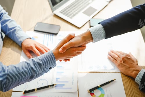 Preview: Businessman conducts financial discussions, sealing deals with handshakes. Expert in accounts, loans