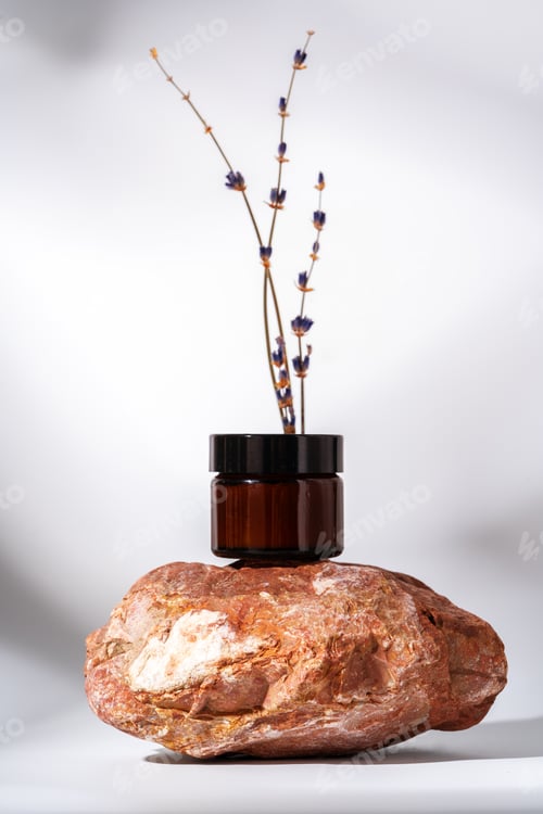 Preview: Cosmetic product jar in composition with granite stones and shadow