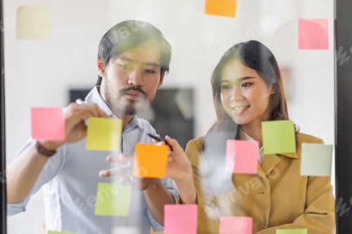 Preview: Team of Business female employee with many conflicting priorities arranging sticky notes commenting