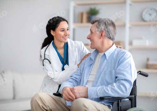 Preview: Caring Doctor Talking With Senior Man in Wheelchair