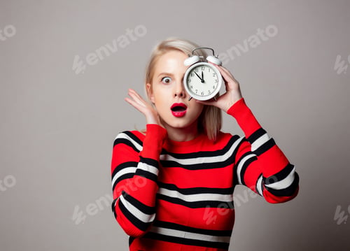 Preview: Style girl in red sweater with alarm clock