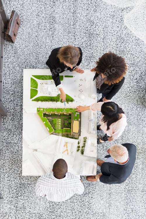Preview: Team of professionals evaluating architectural model