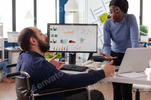Preview: Handicapped paralyzed businessman showing financial graphs on computer