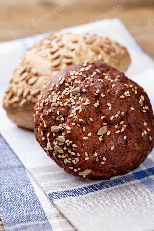 Preview: Freshly baked bread on dark gray kitchen table, top view.