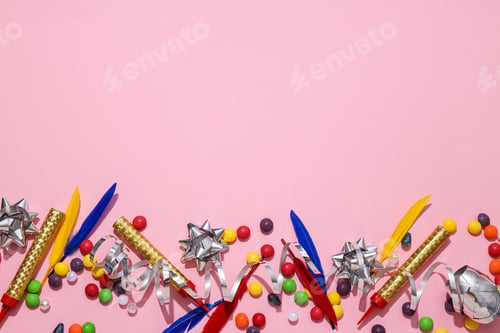 Preview: Candies, feathers and serpentine on pink background, space for text